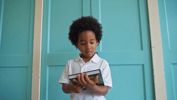 A kid is reading a book